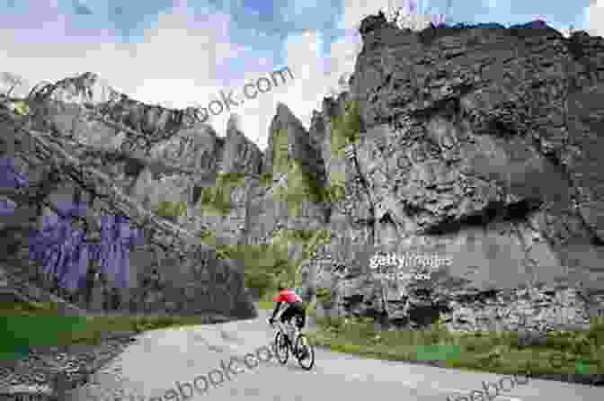 A Cyclist Riding Through The Dramatic Limestone Gorge Of Winnats Pass, Surrounded By Towering Cliffs. Cycling Climbs Of Yorkshire (Regional Cycling Climbs 2)